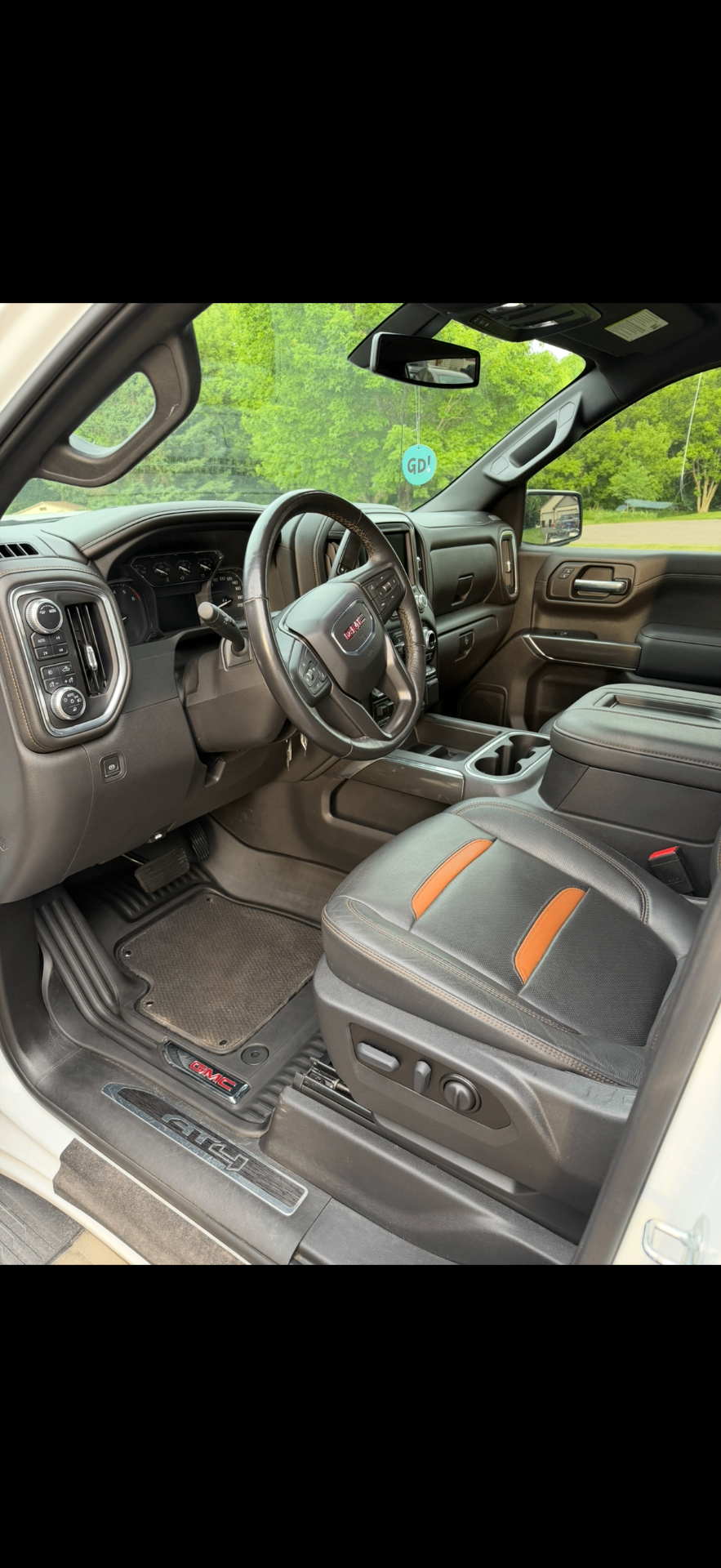Detailed GMC AT4 interior with clean leather seats and floor mats
