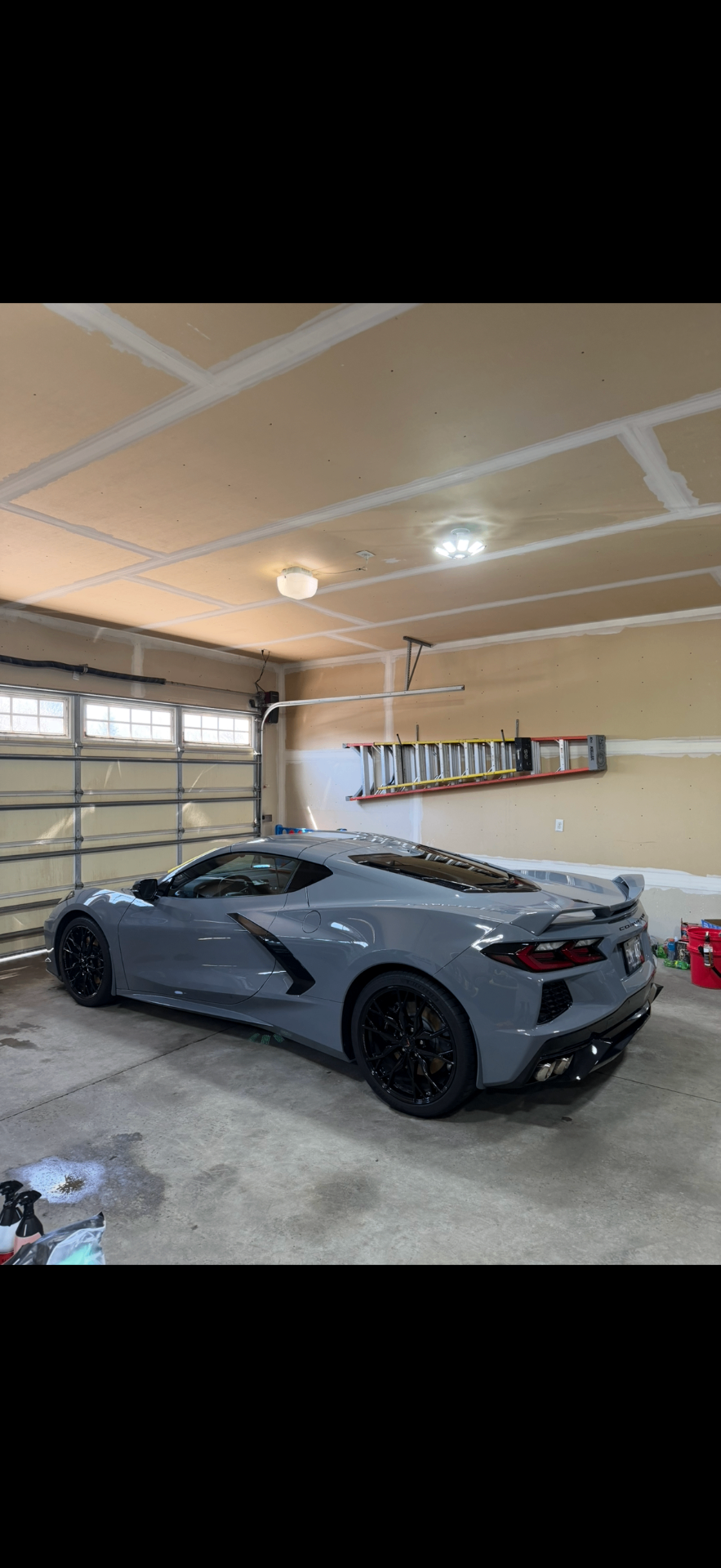 Gray Corvette after detailing inside a garage