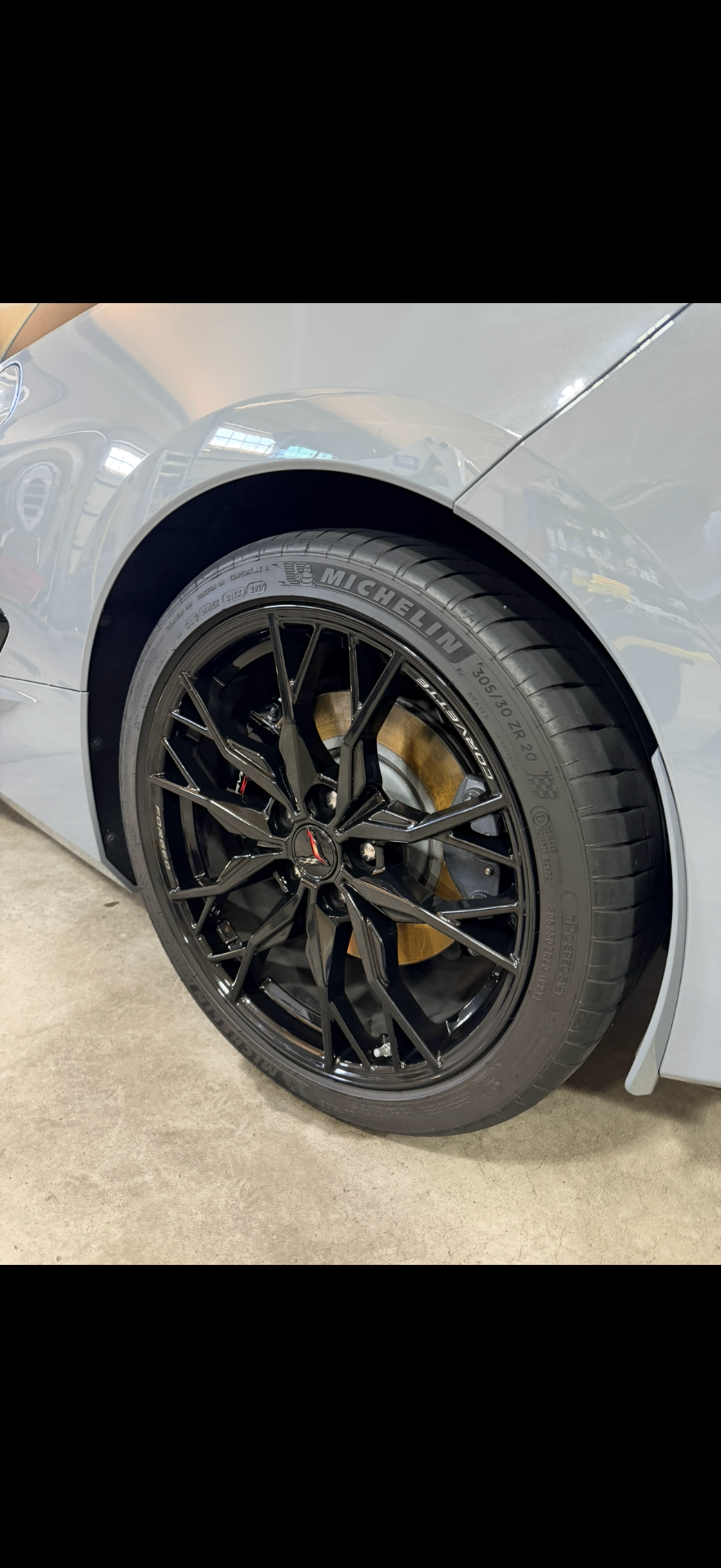 Close-up of a detailed Corvette wheel and tire