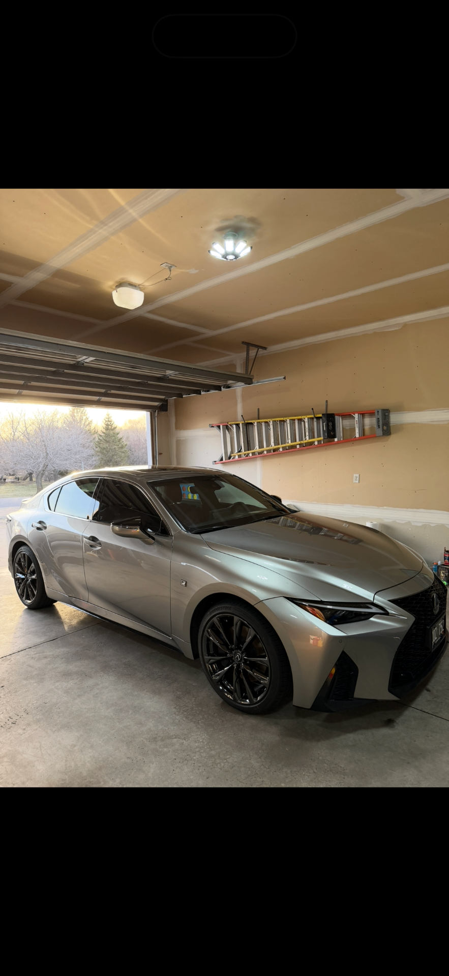 Silver Lexus sedan after detailing in a garage
